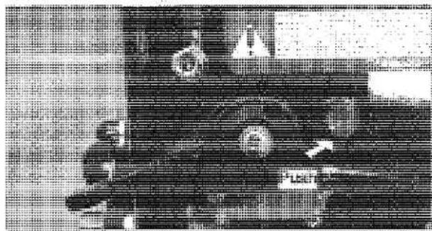 Scanned text image with fragmented characters and symbols, possibly from a document or form