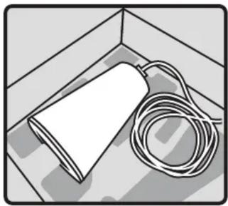 Illustration of a white cylindrical object with a coiled cable placed on a tiled floor (no text or symbols)