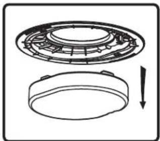 Technical line drawing of a mechanical component with a circular housing and a separate circular base, showing internal structure and a downward arrow (no text or symbols)