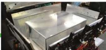 Industrial machine component with metallic frame and wiring (no visible text or symbols)