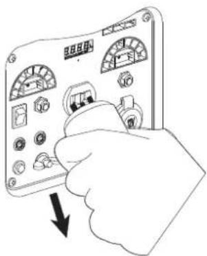 Illustration of a hand holding an analog multimeter with labeled buttons and a downward arrow indicating action or change.