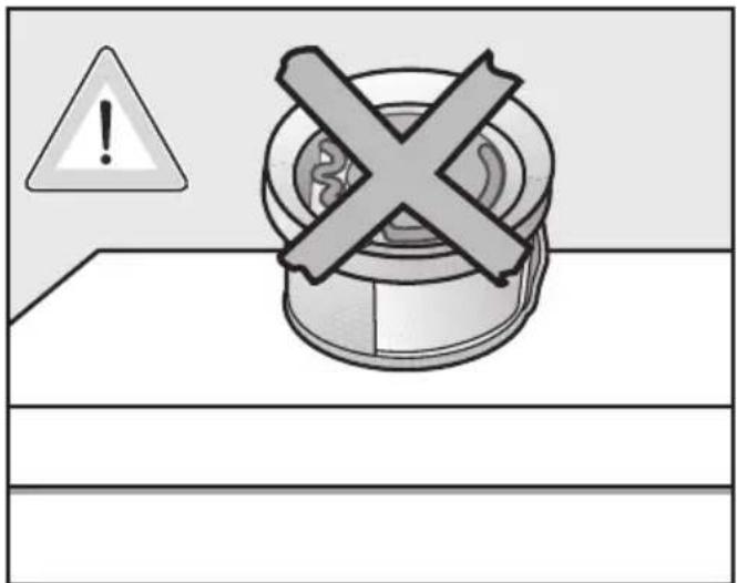 Warning symbol with warning triangle and cross mark on a mechanical component, likely indicating incorrect safety or hazard.