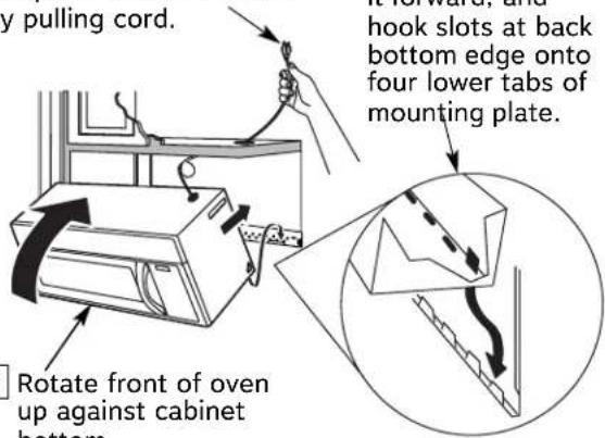 y pulling cord. hook slots at back bottom edge onto four lower tabs of mounting plate. Rotate front of oven up against cabinet bottom.