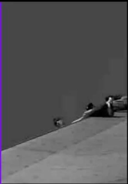 Black-and-white photo of two people lying on a slope, no visible text or symbols