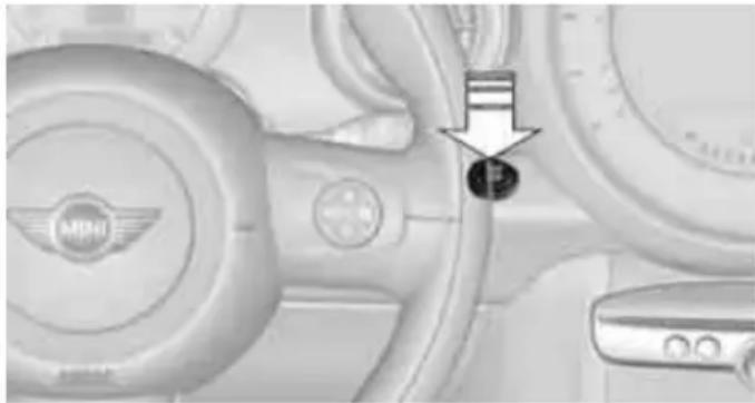 Close-up of a car interior showing steering wheel, dashboard, and keyway (no visible text or symbols)