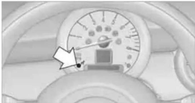 Close-up of a car dashboard with a speedometer and a small electronic device, no visible text or symbols.