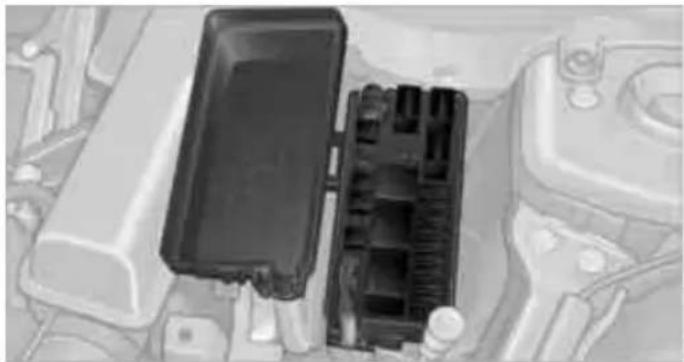 Close-up of a car engine bay panel showing internal components (no visible text or symbols)
