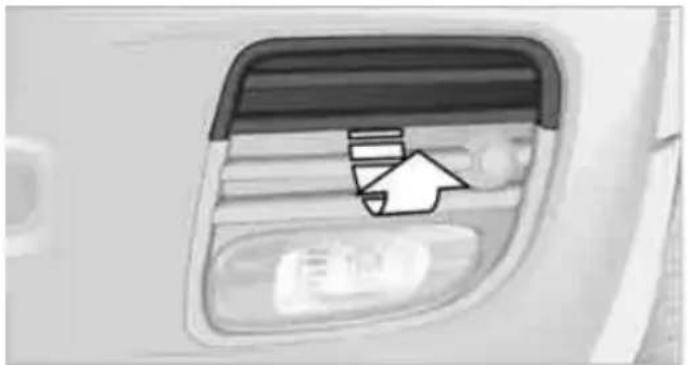 Close-up of a car's side window with a white arrow pointing to the bottom panel (no text or symbols visible)