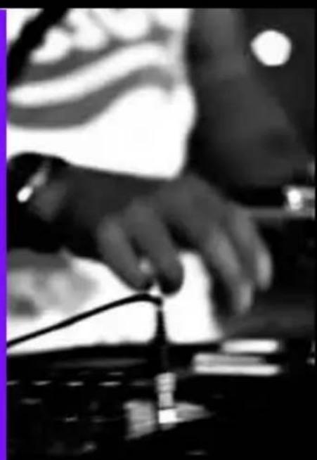 Black-and-white photo of a person playing a keyboard with a blurred background (no visible text or symbols)
