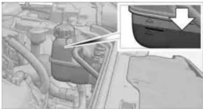 Industrial machinery component with pipes and a magnified inset showing a blue container (no visible text or symbols)