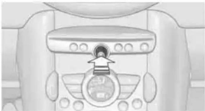 Top-down view of a car dashboard with a circular vent and directional arrow (no text or symbols)
