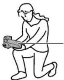 Line drawing of a person in a kneeling pose holding a tool or object, with no text or symbols present.