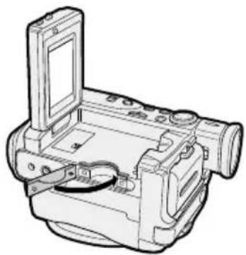 Line drawing of a vintage digital camera with lens and control panel (no text or symbols).