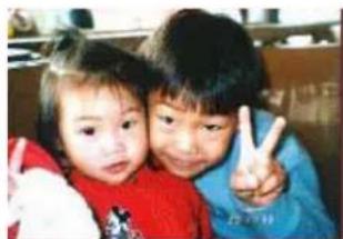 Two children making a peace sign together (no visible text or symbols)