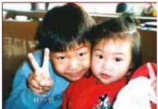 Two children making a peace sign together (no visible text or symbols)