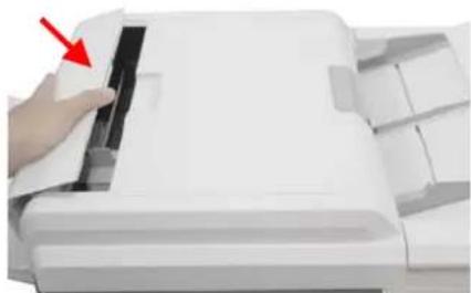 Close-up of a hand pressing down on a white paper airplane wing (no text or symbols visible)