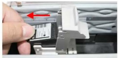 Close-up of a hand inserting a card into a plastic enclosure with a red arrow indicating direction (no text or symbols visible)