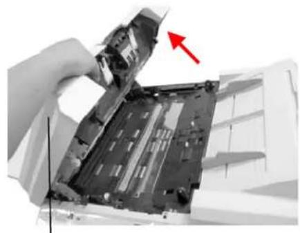 Close-up of hands holding a device with a red arrow pointing to a component (no visible text or symbols)