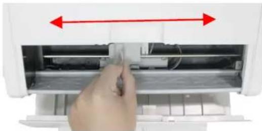 Hand inserting a component into an air conditioner unit, showing internal components and airflow direction (no text or symbols visible)