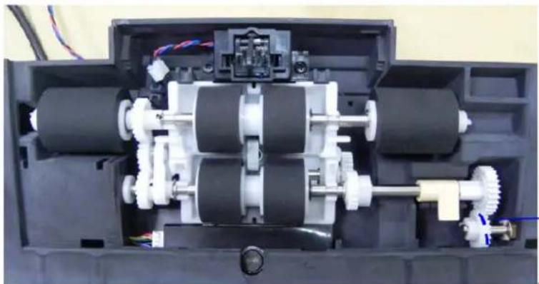 Internal view of a mechanical device showing internal gears and shafts (no text or symbols visible)