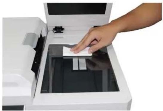 Hand placing a white paper into a white printer case (no text or symbols visible)