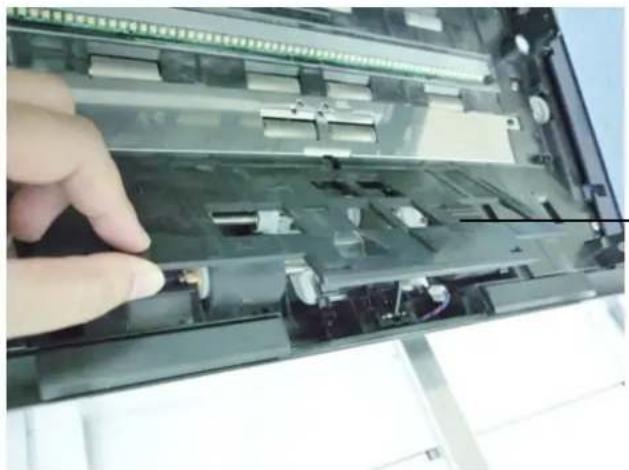 Close-up of a hand inserting or adjusting a device into a circuit board (no visible text or symbols)