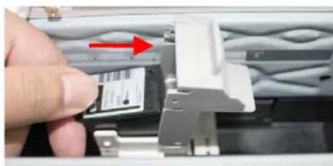 Close-up of a hand inserting a small electronic component into a metal bracket (no visible text or symbols)