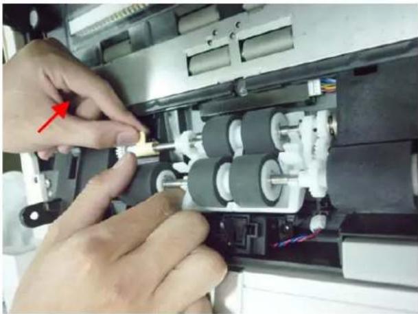 Close-up of hands assembling or adjusting mechanical components in an open device (no visible text or symbols)