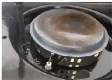 Close-up of a mechanical component with a circular housing and mounting bracket (no visible text or symbols)