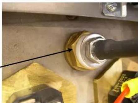 Close-up of a mechanical component with a black pipe fitting and a blue bolt, no visible text or symbols