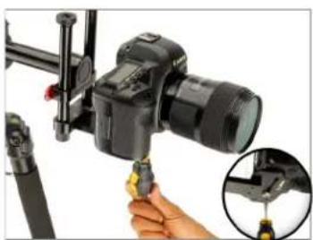 Close-up of a camera setup with a DSLR camera mounted on a tripod, showing a hand adjusting the cable (no text or symbols visible)