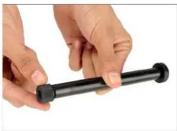 Close-up of hands holding a black cylindrical object (no text or symbols visible)