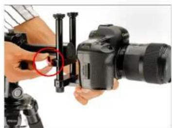 Close-up of a person using a DSLR camera with a red circular annotation highlighting the lens (no text or symbols visible)