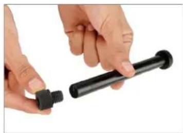 Close-up of hands holding a black plastic mechanical component (no text or symbols visible)