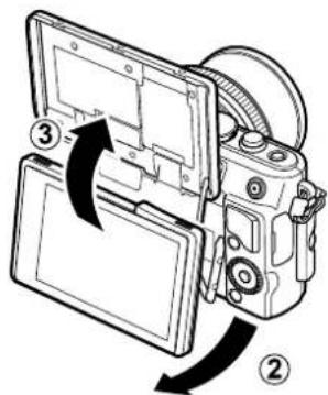 Diagram of a digital camera with labeled parts and directional arrows indicating assembly or operation