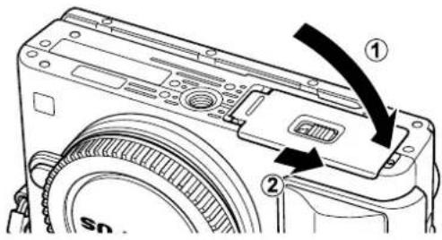 Diagram of a camera module with labeled parts and directional arrows indicating assembly or movement