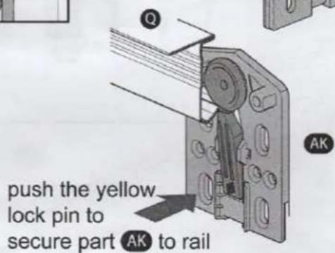 push the yellow lock pin to secure part AK to rail
