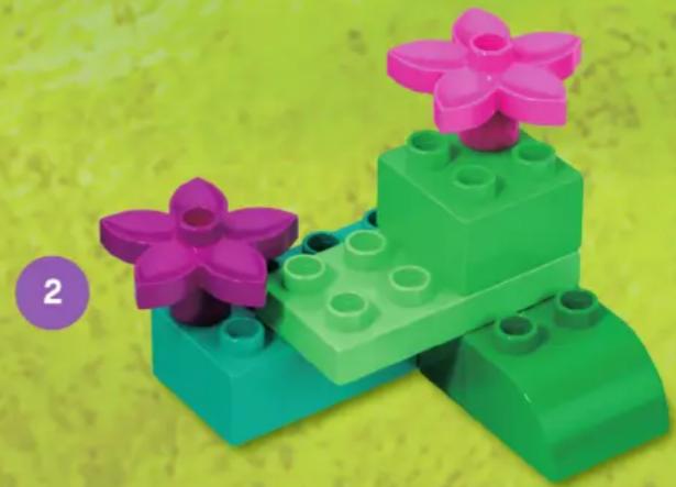 Colorful LEGO building blocks with purple and pink flower-like tops, set against a yellow textured background (no text or symbols)