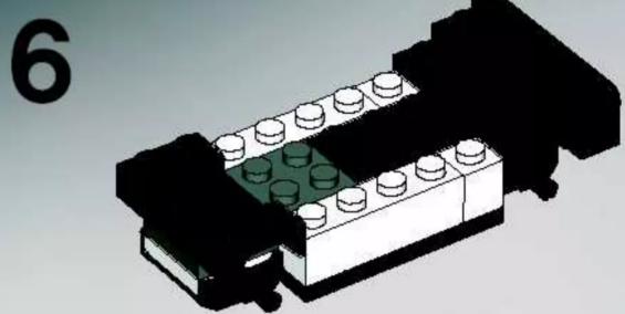 3D diagram of a LEGO brick structure with green and white components, no text or symbols present