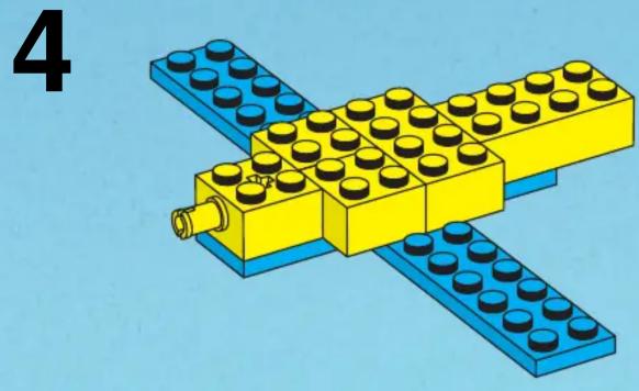 Illustration of a yellow and blue LEGO brick structure with a pipe, no text or symbols present