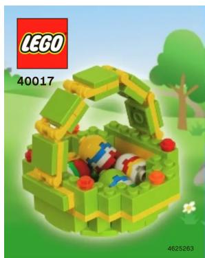 Green LEGO-style structure with a wooden frame and cartoon figures inside, set against a green landscape background (no text or symbols on the structure itself)