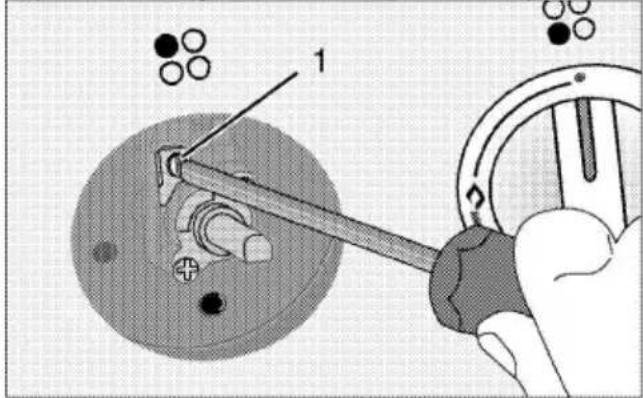 Technical diagram showing a hand operating a tool to adjust or install a mechanical component, with labeled parts and directional arrows.