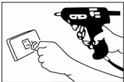 Illustration showing a hand holding a small card with a tool, possibly a tool or device, next to a document labeled 'E'.