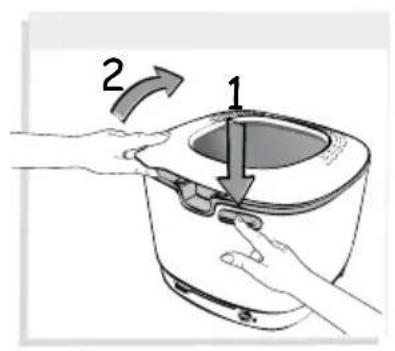 Diagram showing a hand pressing a component into a kettle with labeled parts 1 and 2, indicating a step in the process.