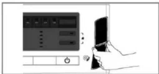 Diagram showing a control panel with buttons and a hand holding a tablet, likely illustrating a device operation or system control.
