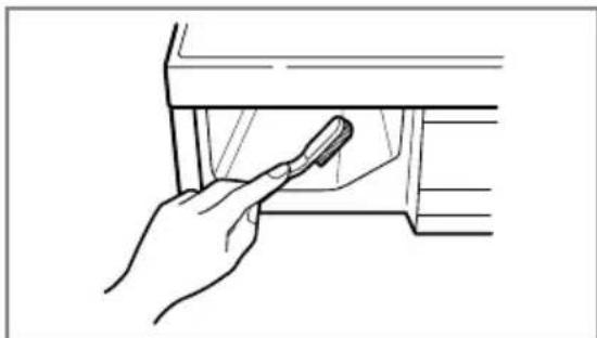 Line drawing of a hand holding a tool inside a container (no text or symbols)