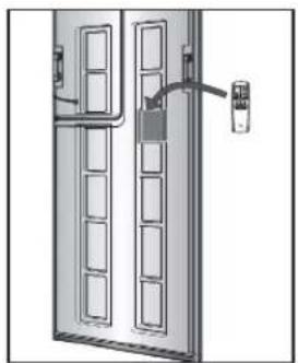 Diagram of a double door with internal compartments and a hanging wall-mounted device (no text or symbols)