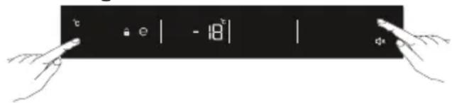 Diagram showing two hands pointing at a black rectangular button with display icons and numerical values, likely from a digital interface.