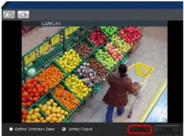 Street photo of a supermarket fruit section with visible price tags and a shopper shopping, showing a person in the foreground.