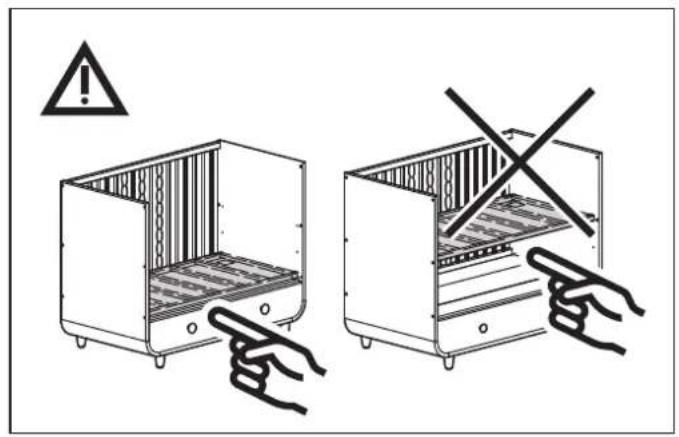 Diagram showing two hand gestures inside a storage cabinet, one with warning symbol and the other crossed out.